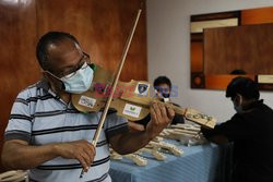 Music teacher designs violin with recycled products